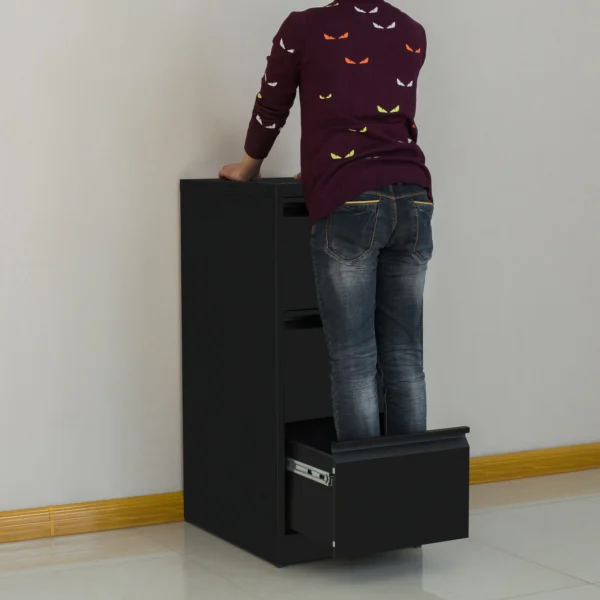 Person using black 4-drawer filing cabinet with open drawer, demonstrating accessibility and storage capacity