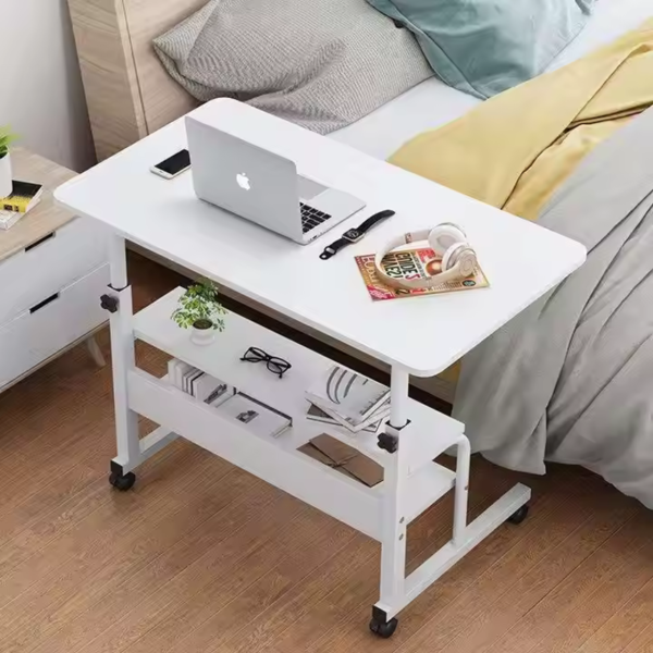 White adjustable desk with storage shelves and laptop on top