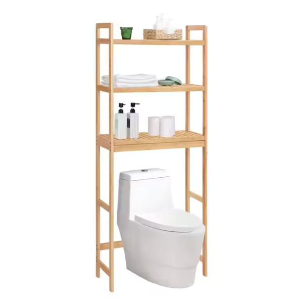Bamboo bathroom storage rack with three shelves placed above a toilet, holding towels, toiletries, and bathroom essentials